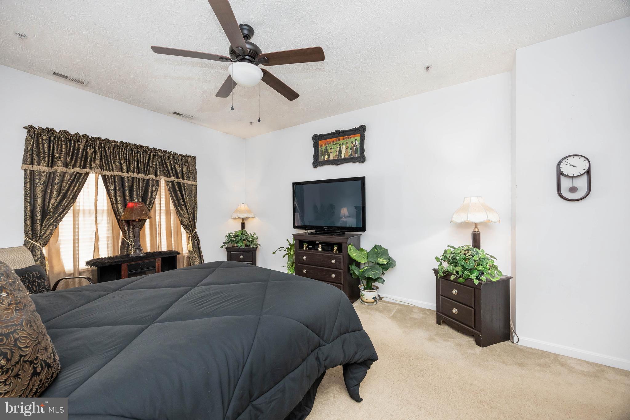 9529 Wedge Way Delmar, MD 21875 - Photo 15 of 39 a bedroom with a bed potted plant on the dresser and a window
