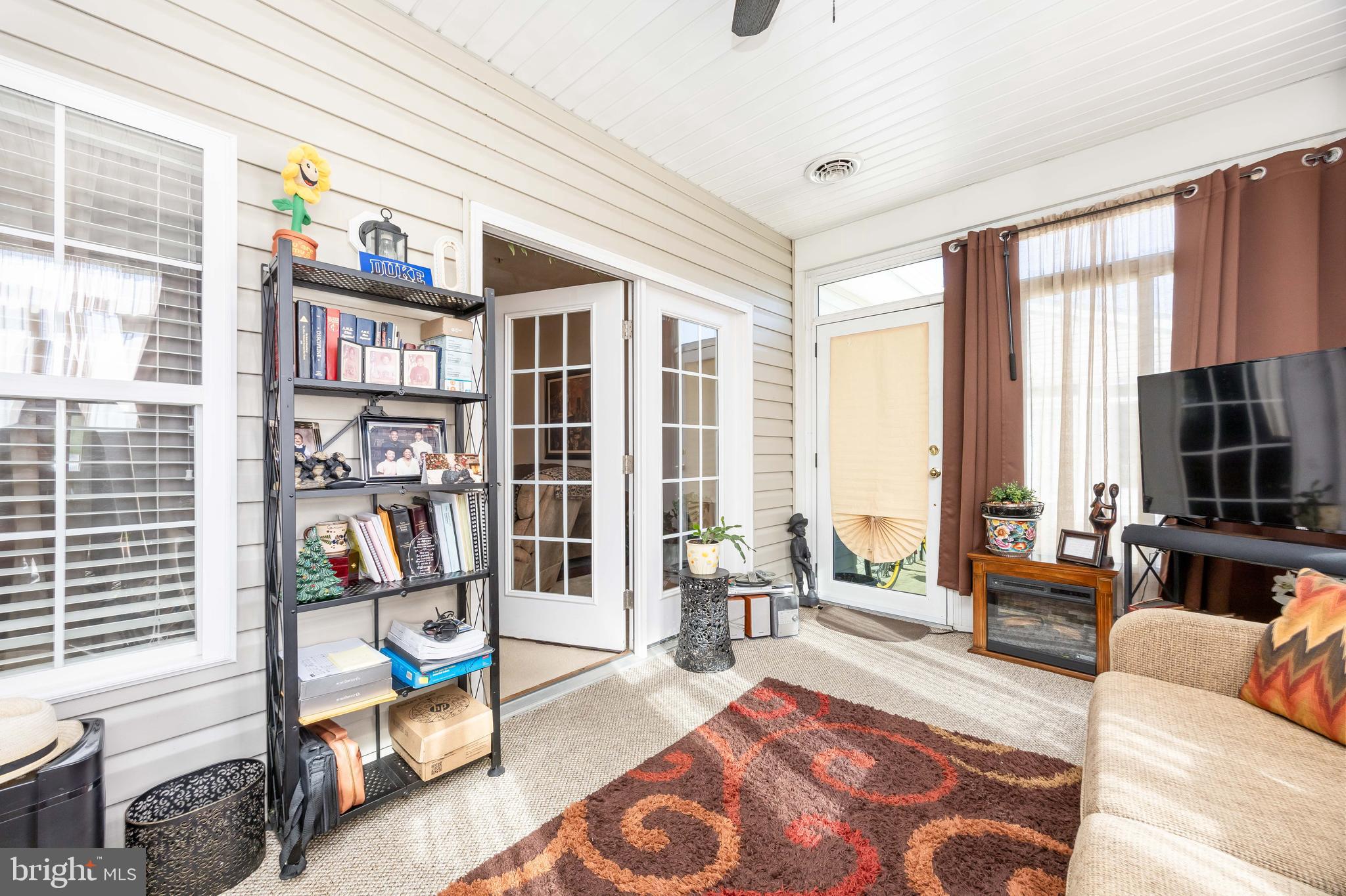 9529 Wedge Way Delmar, MD 21875 - Photo 21 of 39 a living room with furniture a bookshelf and a large window