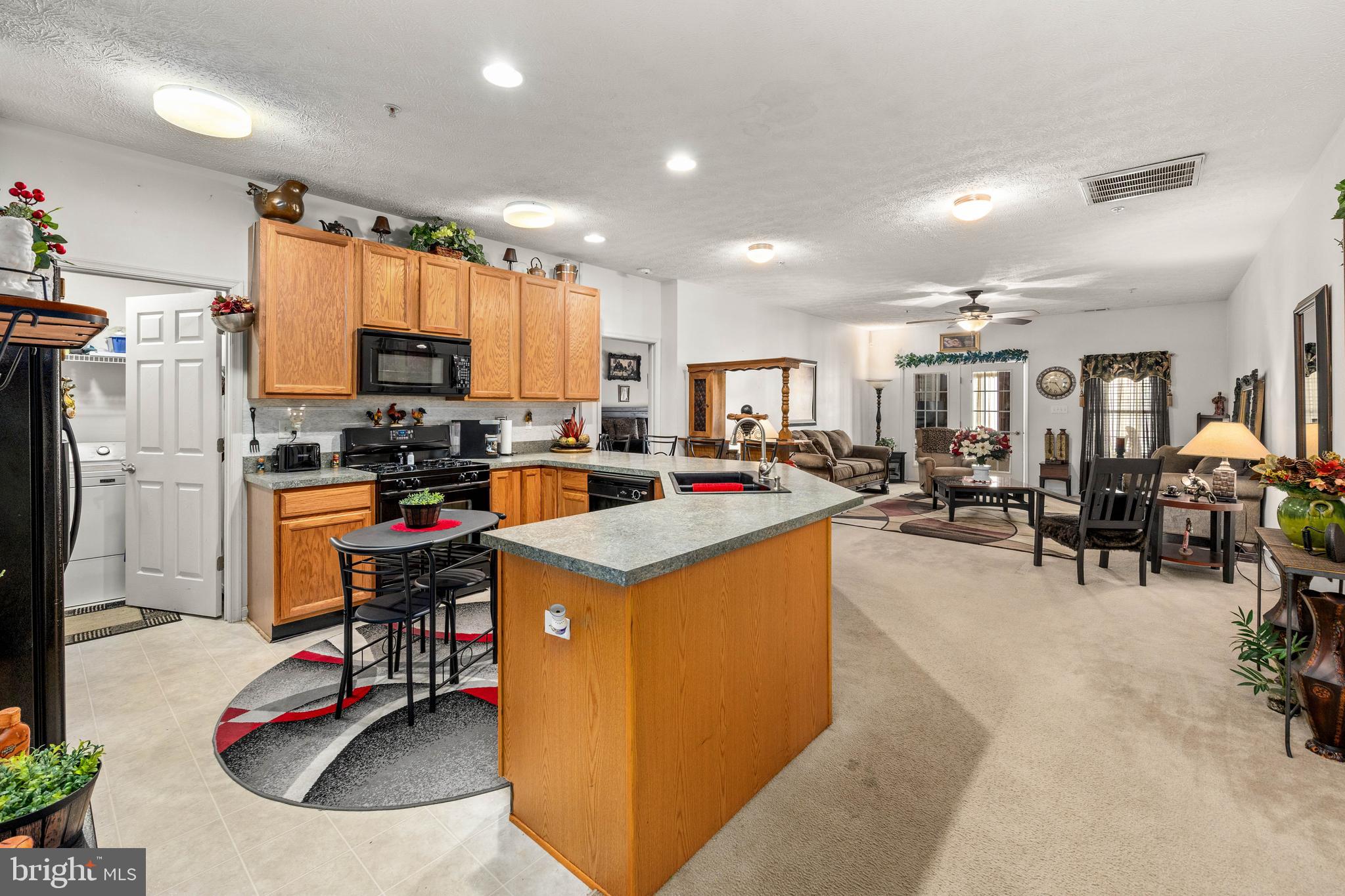 9529 Wedge Way Delmar, MD 21875 - Photo 5 of 39 a kitchen with stainless steel appliances kitchen island granite countertop a refrigerator and a sink