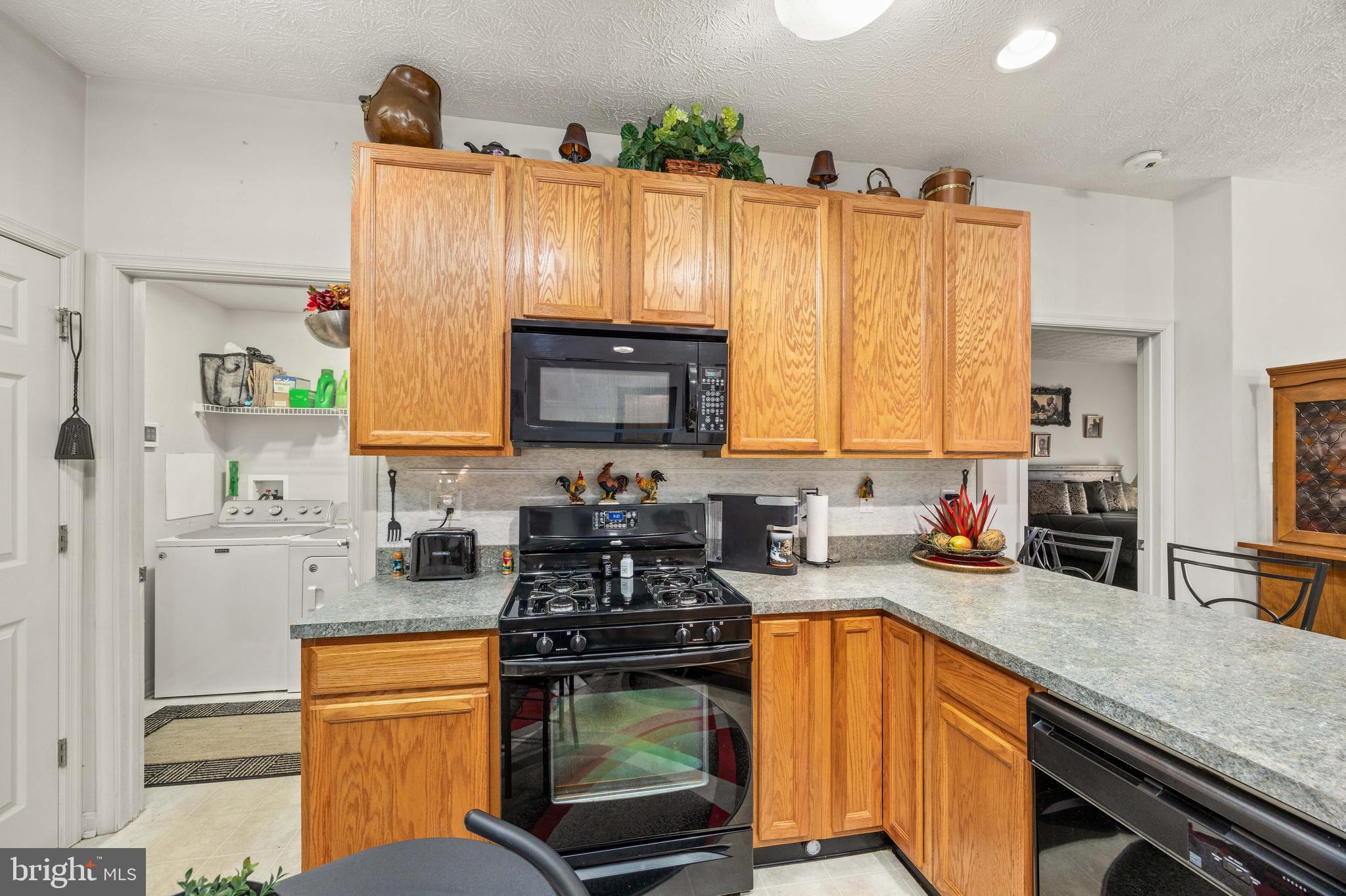 9529 Wedge Way Delmar, MD 21875 - Photo 7 of 39 a kitchen with stainless steel appliances granite countertop a sink a stove cabinets counter space and a window
