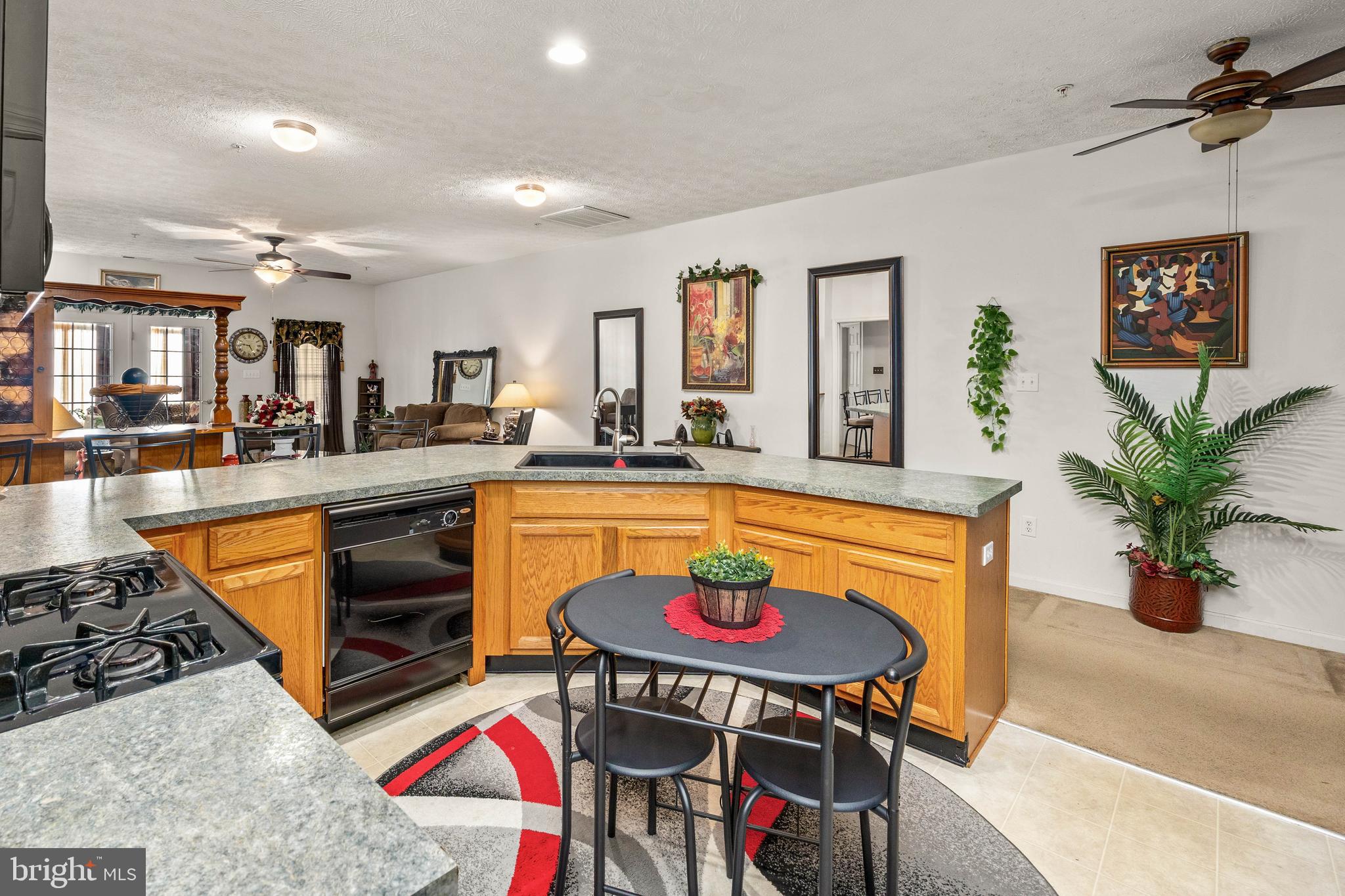 9529 Wedge Way Delmar, MD 21875 - Photo 10 of 39 a kitchen with stainless steel appliances granite countertop a sink a stove and a wooden floors