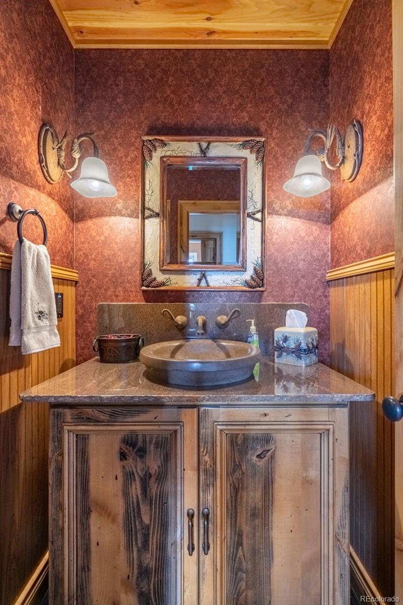 157 Cap Rock Road Canon City, CO 81212 - Photo 15 of 50 a bathroom with a granite countertop sink a mirror and vanity