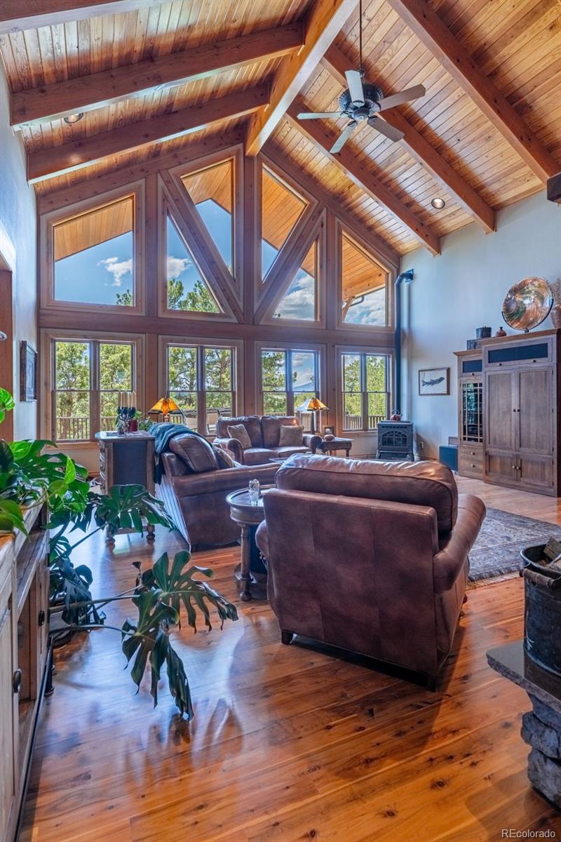 157 Cap Rock Road Canon City, CO 81212 - Photo 16 of 50 a living room with furniture large windows and wooden floor