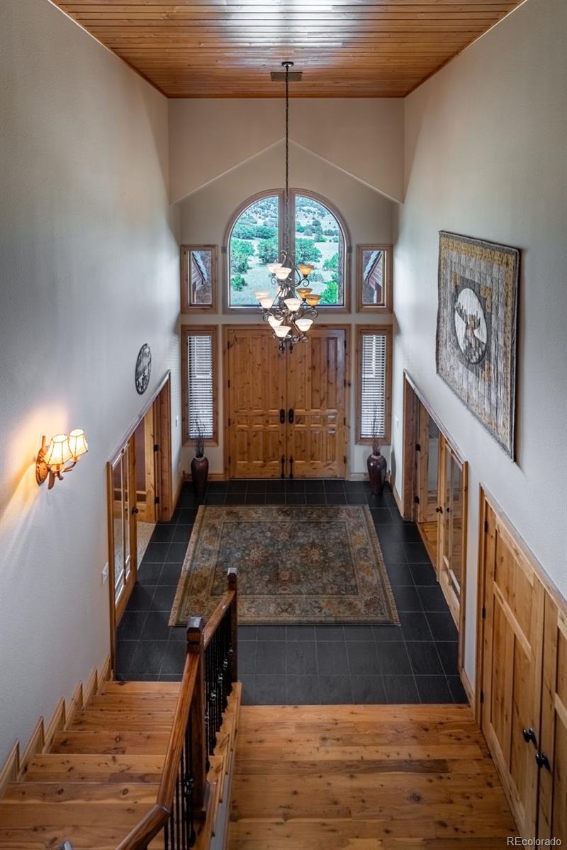 157 Cap Rock Road Canon City, CO 81212 - Photo 24 of 50 a view of a livingroom with wooden floor and a chandelier