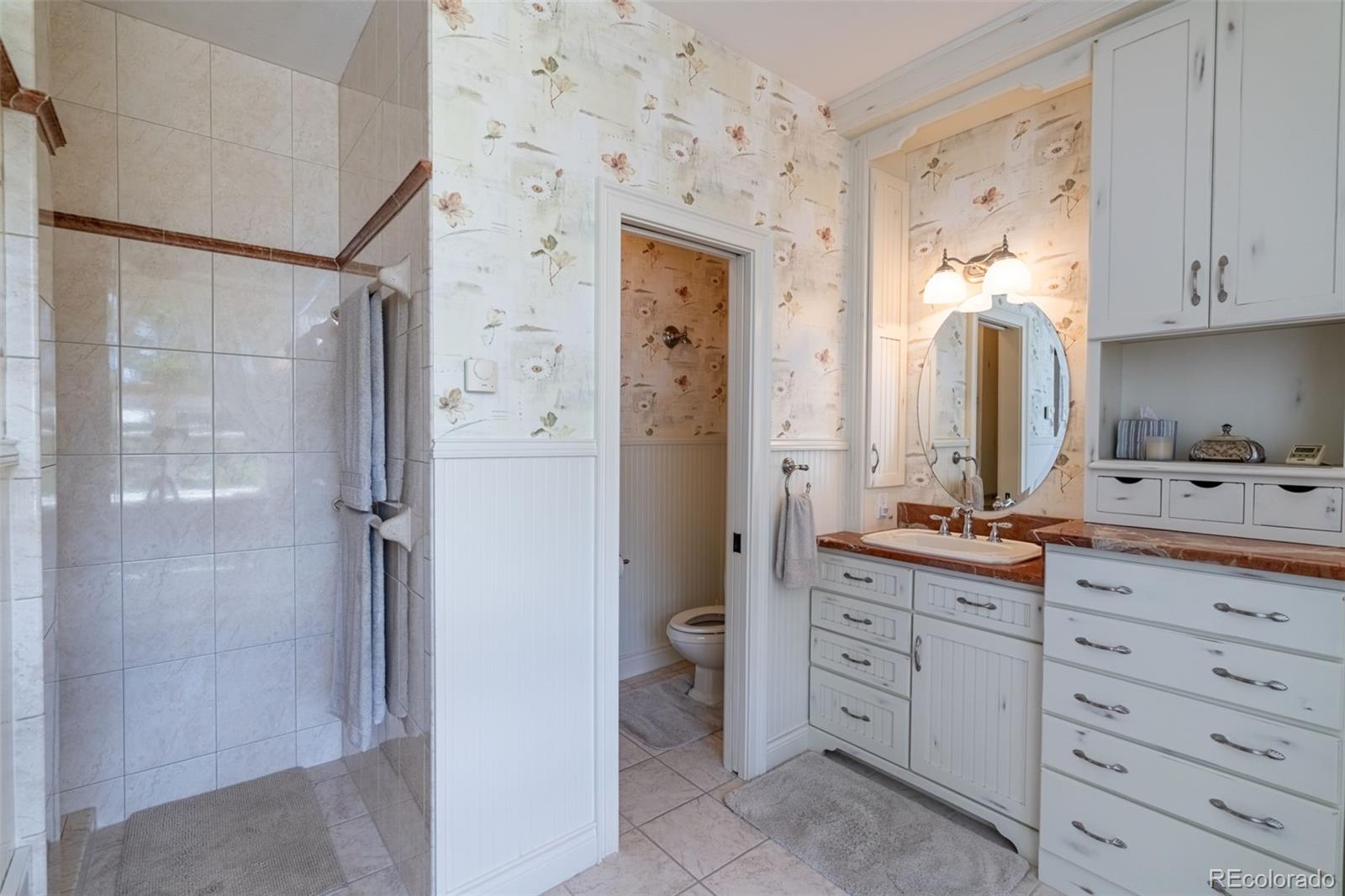 157 Cap Rock Road Canon City, CO 81212 - Photo 34 of 50 a spacious bathroom with a double vanity sink a mirror and a shower