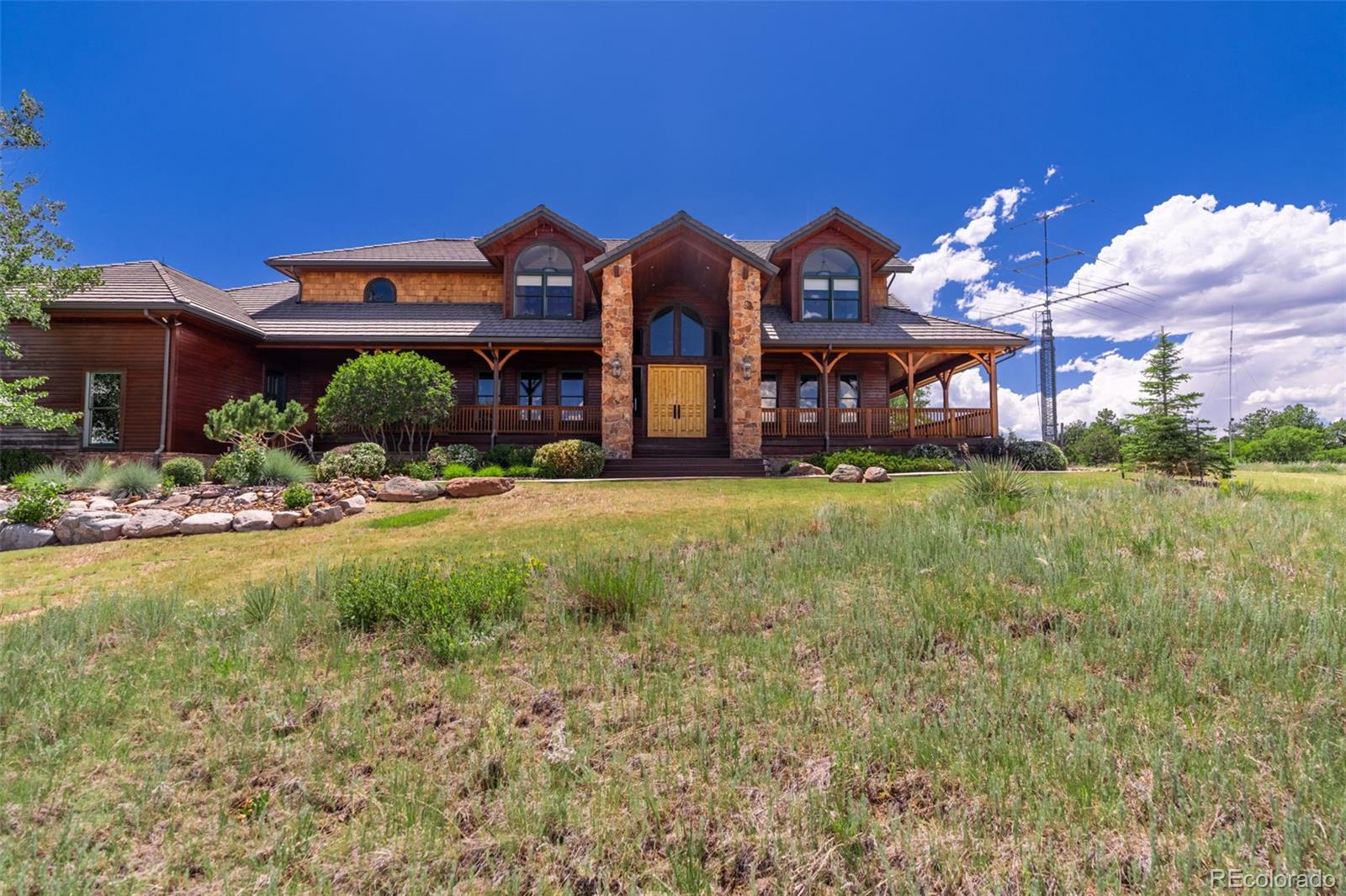 157 Cap Rock Road Canon City, CO 81212 - Photo 46 of 50 a front view of a house with a yard and a large tree