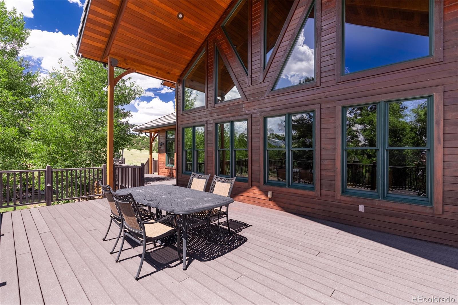 157 Cap Rock Road Canon City, CO 81212 - Photo 48 of 50 a view of a patio with table and chairs and wooden floor