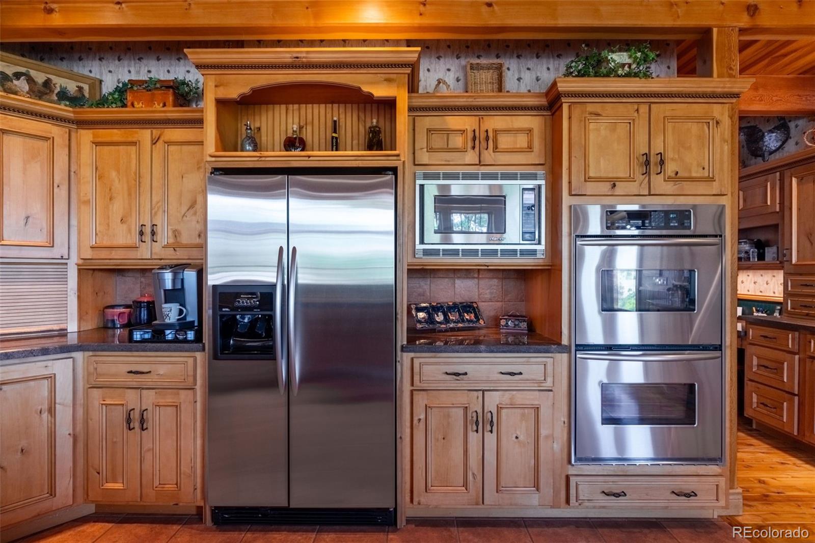 157 Cap Rock Road Canon City, CO 81212 - Photo 8 of 50 a kitchen with stainless steel appliances granite countertop a refrigerator and a stove