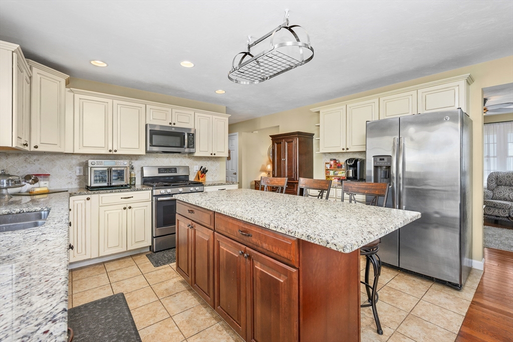 138 Sprague Street Fall River, MA 02724 - Photo 8 of 34 a kitchen with stainless steel appliances granite countertop a sink refrigerator and cabinets
