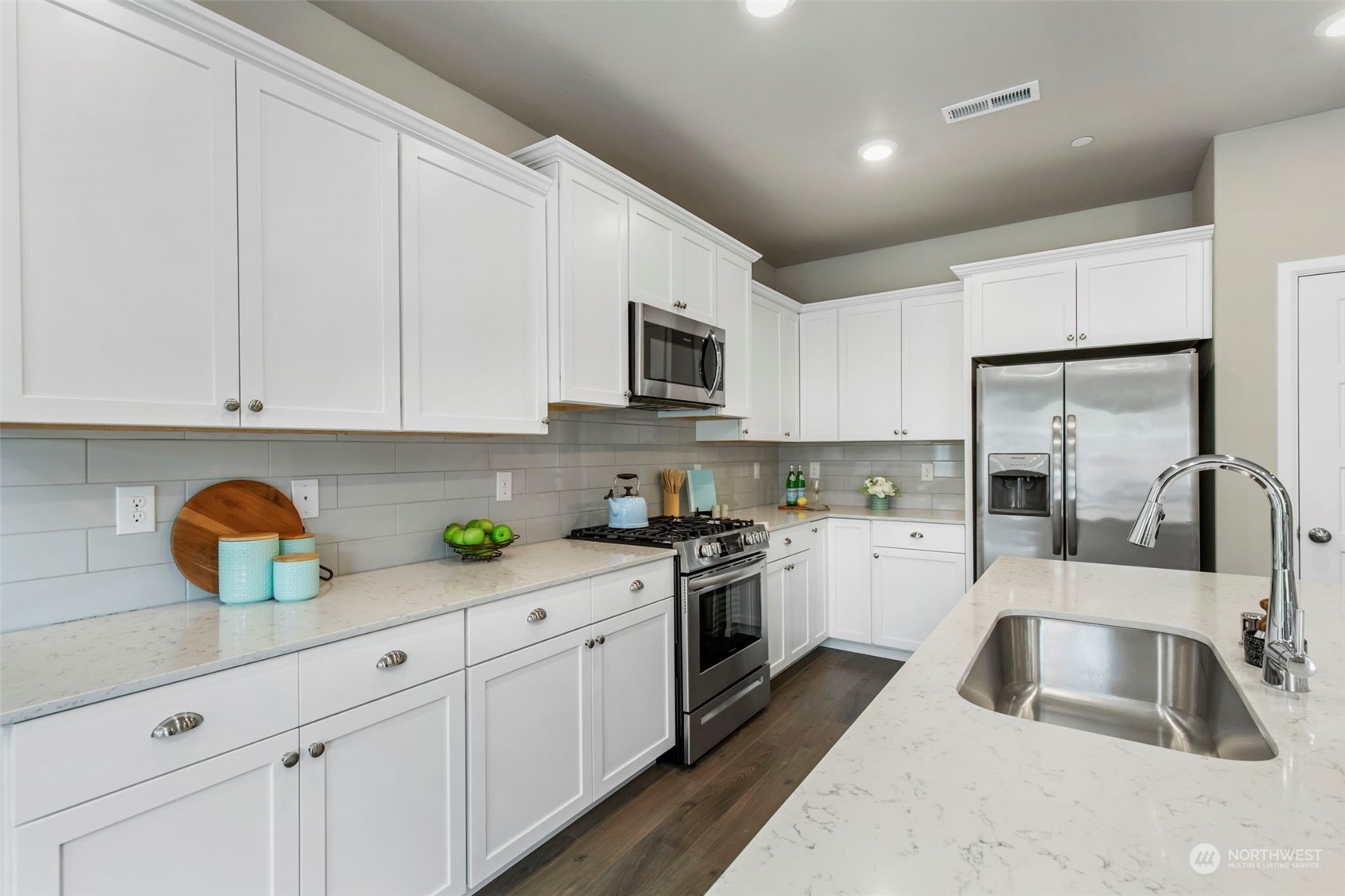 1496 Baker Heights Loop Bremerton, WA 98312 - Photo 11 of 27 a kitchen with cabinets a sink and appliances