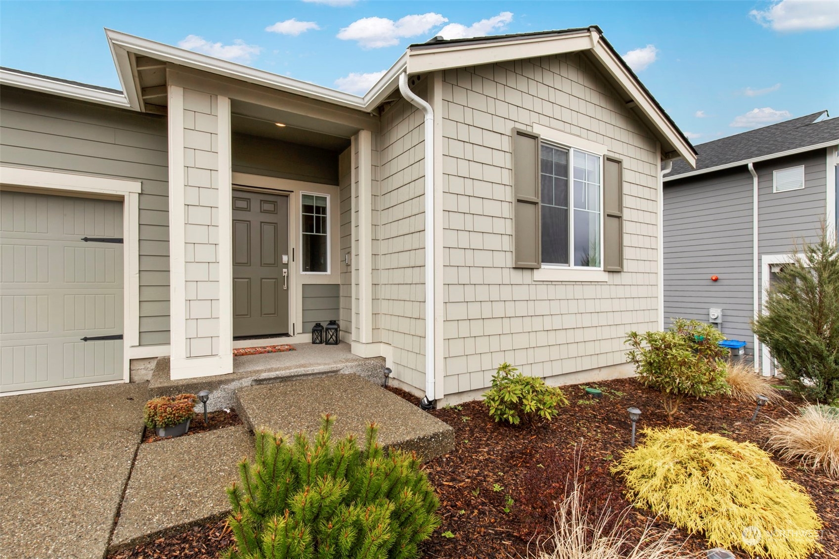 1496 Baker Heights Loop Bremerton, WA 98312 - Photo 3 of 27 a front view of a house with garden