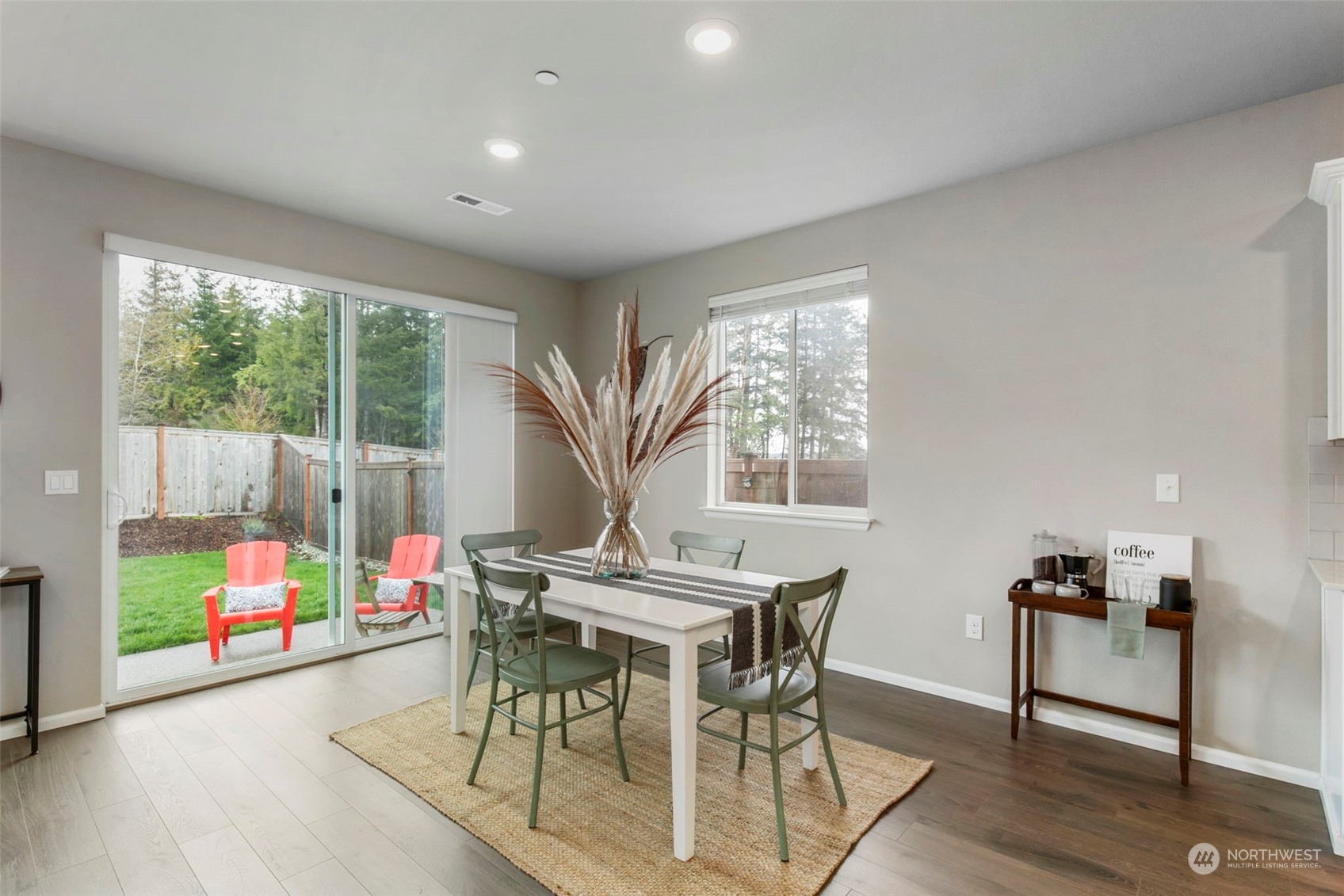 1496 Baker Heights Loop Bremerton, WA 98312 - Photo 8 of 27 a view of a dining room with furniture a rug and wooden floor
