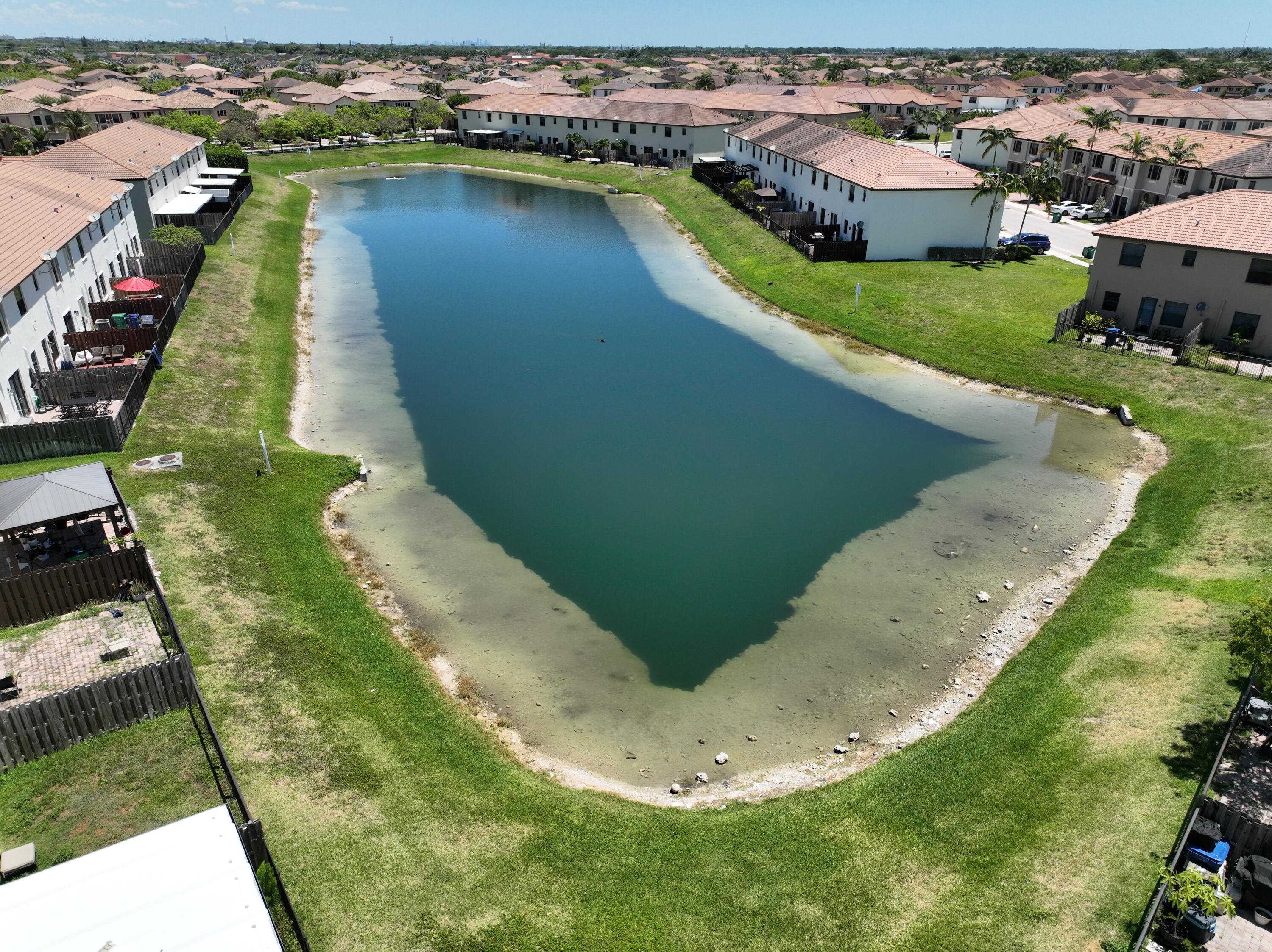 23765 Southwest 118 Avenue, Unit 23765 Homestead, FL 33032 - Photo 26 of 36 a view of a lake with a house