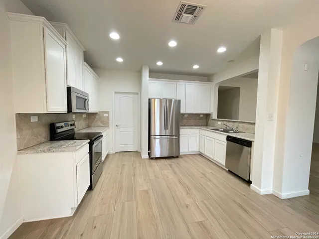 a kitchen with a refrigerator a sink and a stove