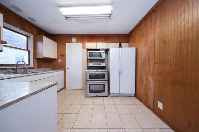 a kitchen with stainless steel appliances a refrigerator and cabinets