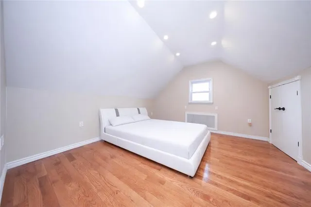 a bedroom with a bed and window