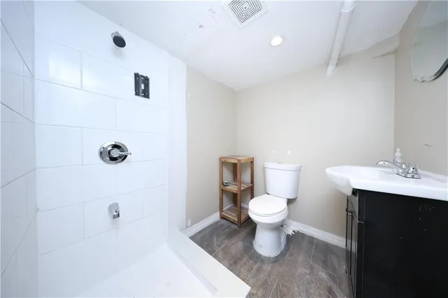 a bathroom with a sink a toilet and a mirror