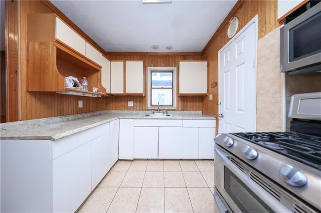 a kitchen with a stove a sink and a microwave