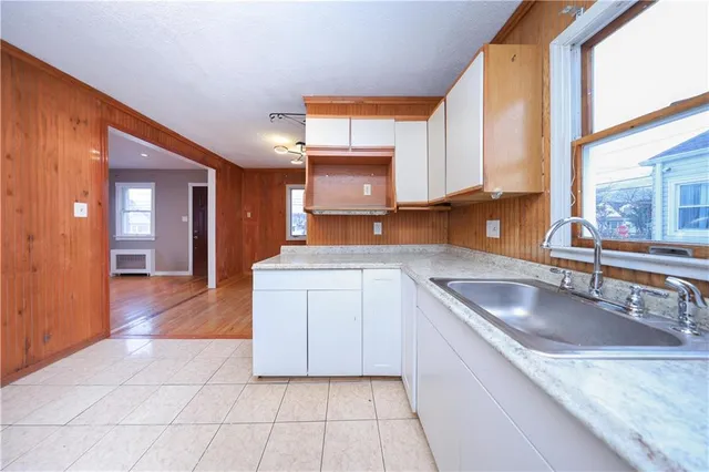 a kitchen with a sink cabinets and window