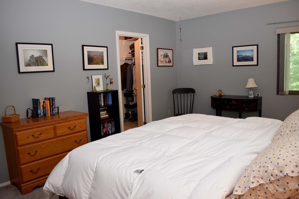6 Round House Road, Unit 6 Bourne, MA 02532 - Photo 12 of 29 a bedroom with a bed and a dresser