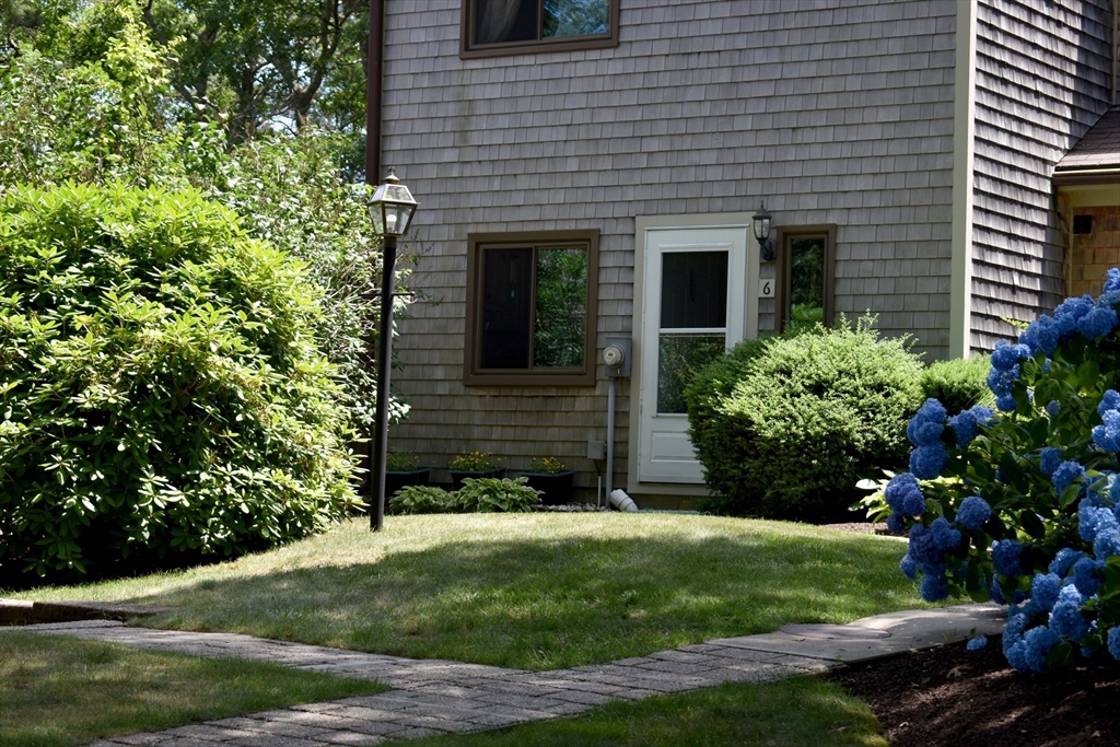6 Round House Road, Unit 6 Bourne, MA 02532 - Photo 2 of 29 a view of a house with a yard and plants