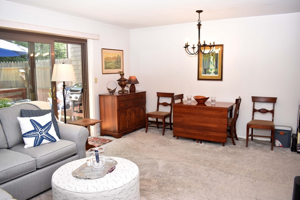 6 Round House Road, Unit 6 Bourne, MA 02532 - Photo 5 of 29 a living room with furniture and a chandelier