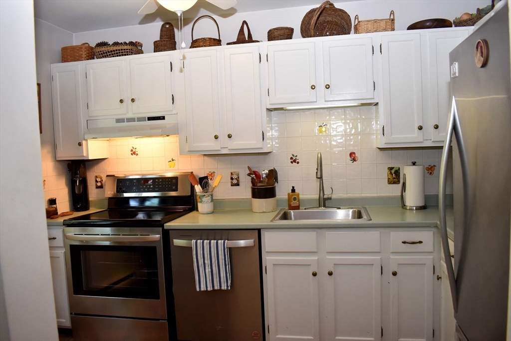 6 Round House Road, Unit 6 Bourne, MA 02532 - Photo 6 of 29 a kitchen with stainless steel appliances granite countertop a sink stove and refrigerator