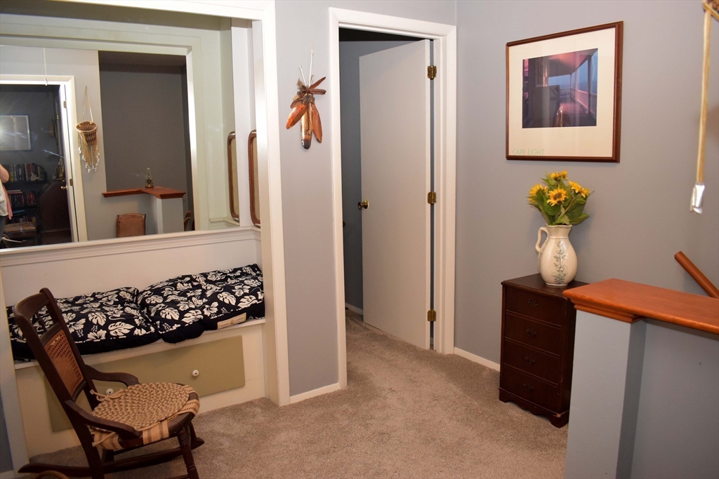 6 Round House Road, Unit 6 Bourne, MA 02532 - Photo 10 of 29 a view of a hallway with wooden floor and a potted plant
