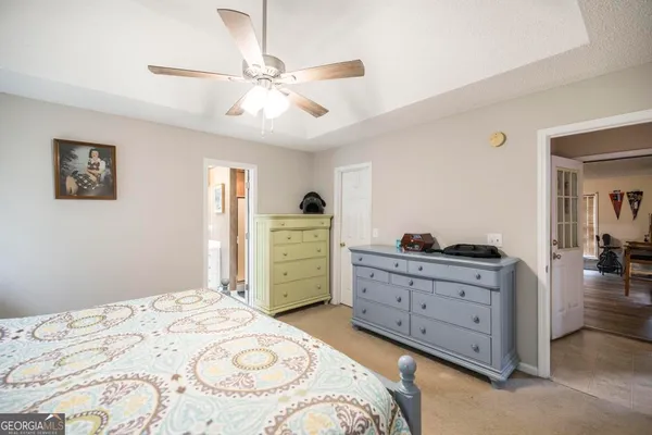 a bedroom with a bed and a dresser