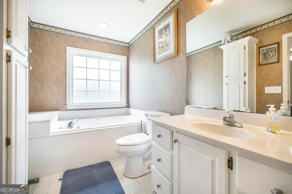 a bathroom with a sink a toilet and a bathtub