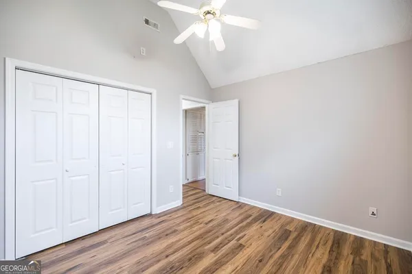 a view of an empty room with wooden floor