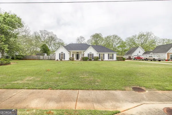 a front view of a house with garden