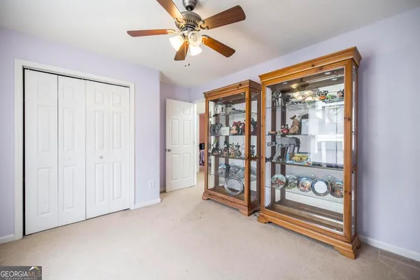 an empty room with chandelier fan