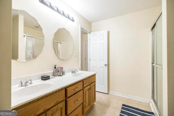 a bathroom with a double vanity sink mirror and a