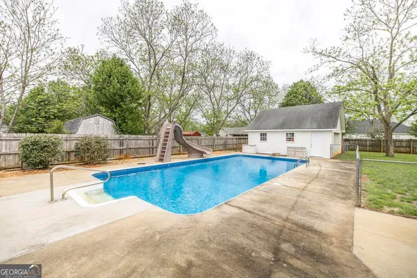 a view of a swimming pool with a patio