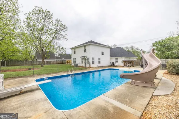a view of a house with swimming pool