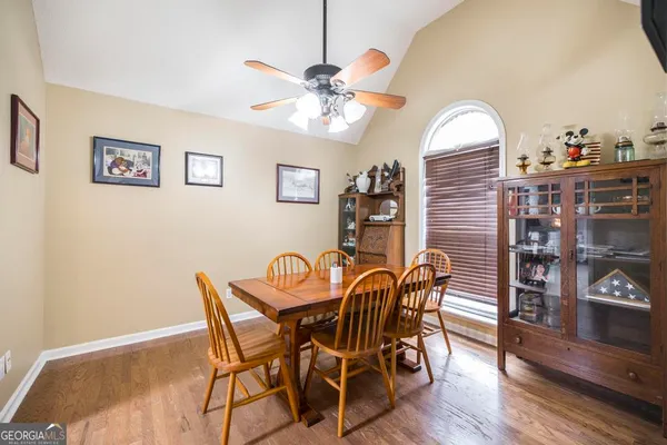 a view of a dining room with furniture and wooden floor