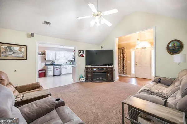 a living room with furniture and a flat screen tv