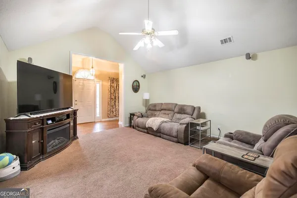 a living room with furniture and a flat screen tv