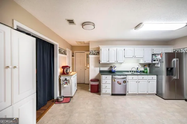 a kitchen with stainless steel appliances a refrigerator sink and stove