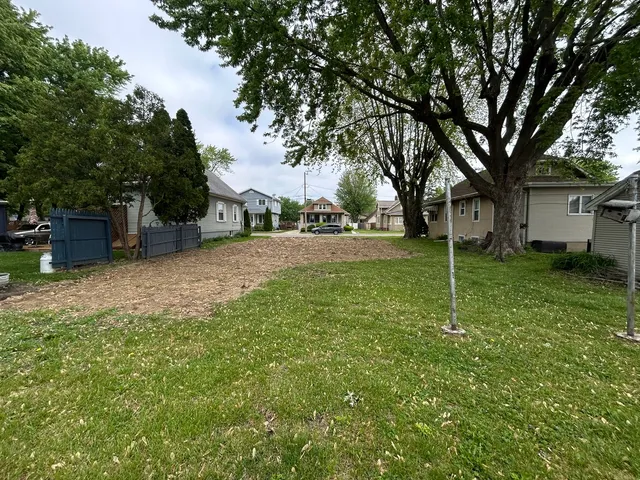 a view of a yard with a house and large tree