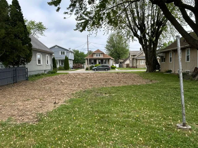 a view of a yard with a house and large tree
