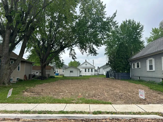 a view of a house with a yard and garage