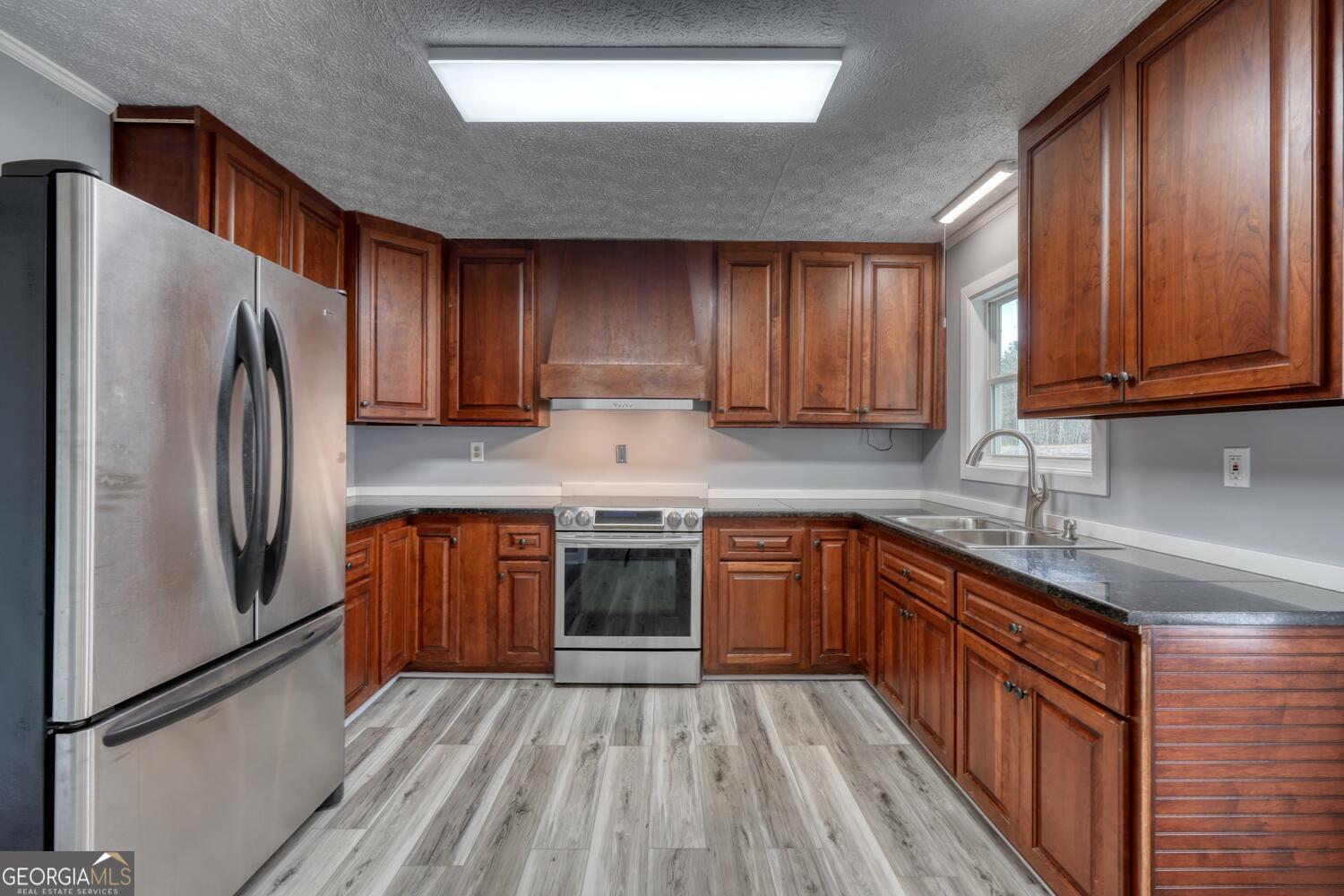 16 Antioch Church Road Blairsville, GA 30512 - Photo 13 of 36 a kitchen with stainless steel appliances granite countertop a refrigerator a sink dishwasher a stove top oven a refrigerator and cabinets