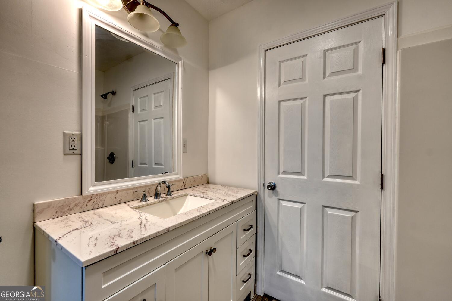 16 Antioch Church Road Blairsville, GA 30512 - Photo 21 of 36 a bathroom with a granite countertop sink and a mirror