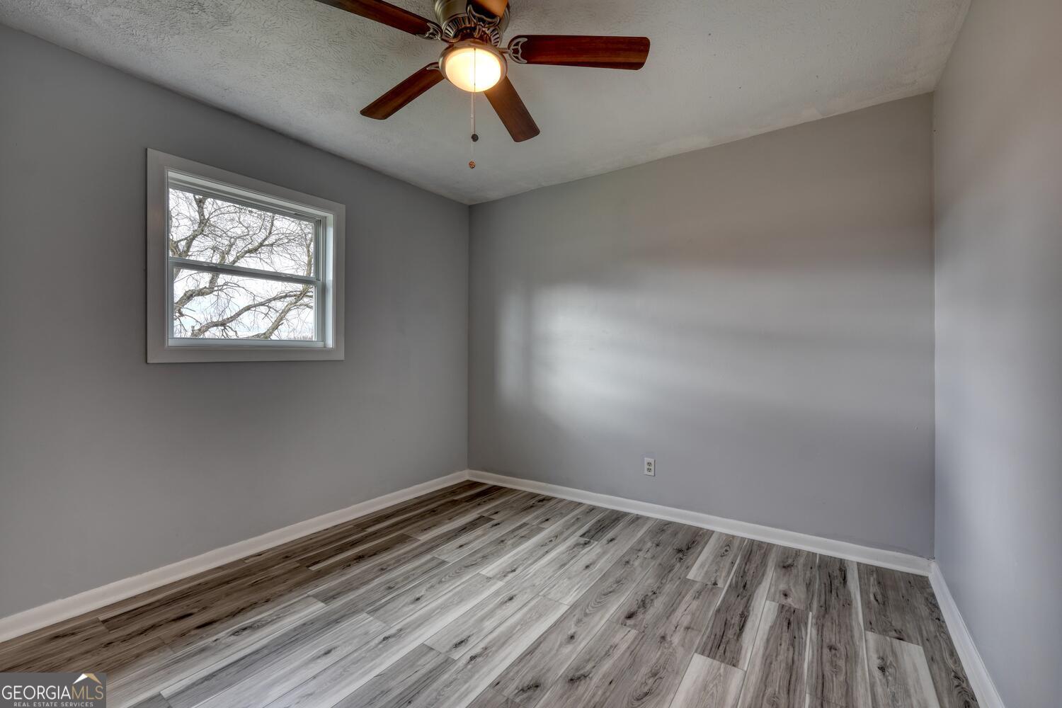 16 Antioch Church Road Blairsville, GA 30512 - Photo 26 of 36 an empty room with a window and a fan