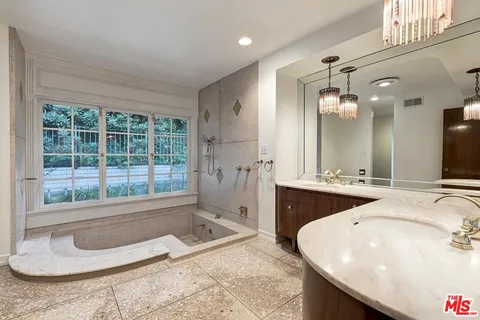 a bathroom with a sink vanity and a mirror