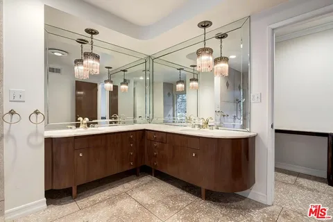 a bathroom with a sink a double vanity and a mirror