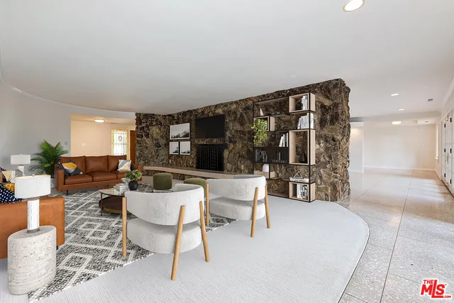 a view of a dining room with furniture a chandelier and wooden floor