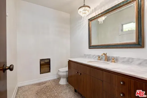 a large kitchen with kitchen island granite countertop wooden cabinets a sink and dishwasher